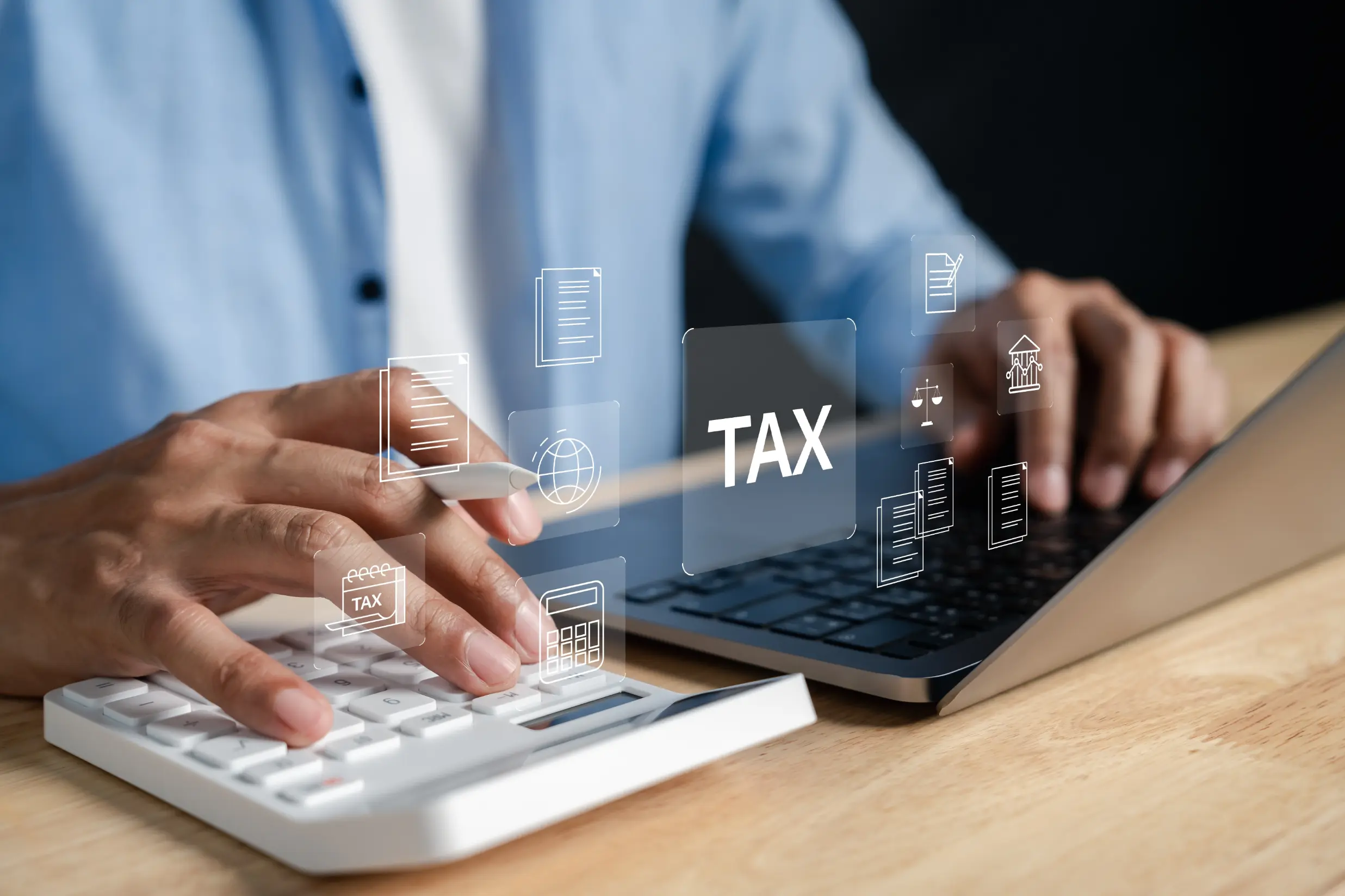Professional using a laptop and calculator while reviewing tax planning strategies for business growth