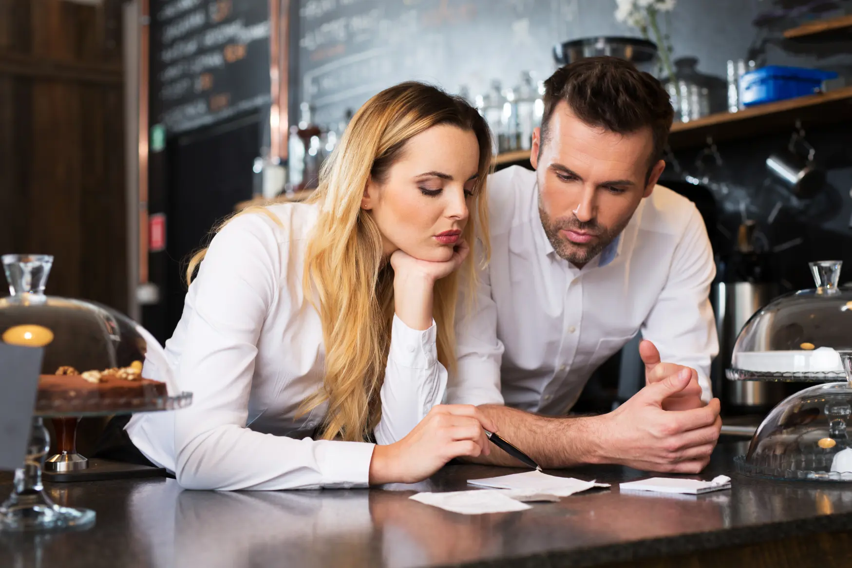 Man and woman reviewing financial documents together during an outsourced CFO services consultation