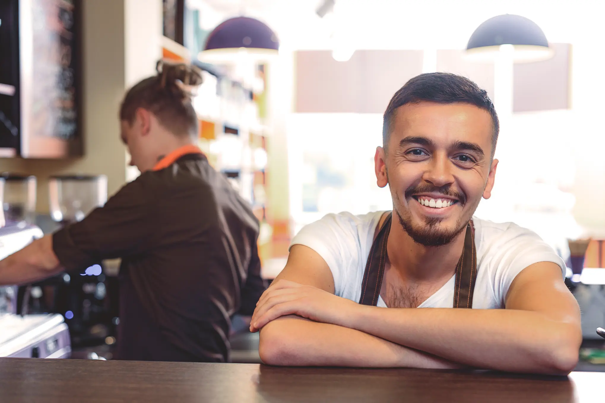 Smiling business owner reflecting on long-term retirement planning and financial security