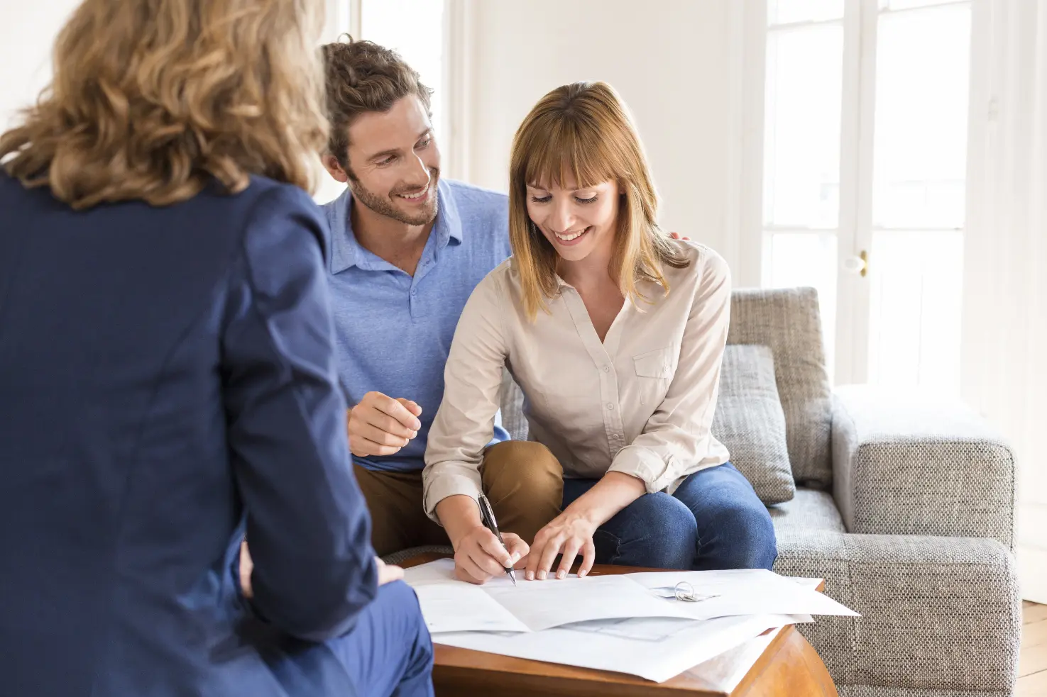 Client signing documents with advisors during a comprehensive financial strategy planning session
